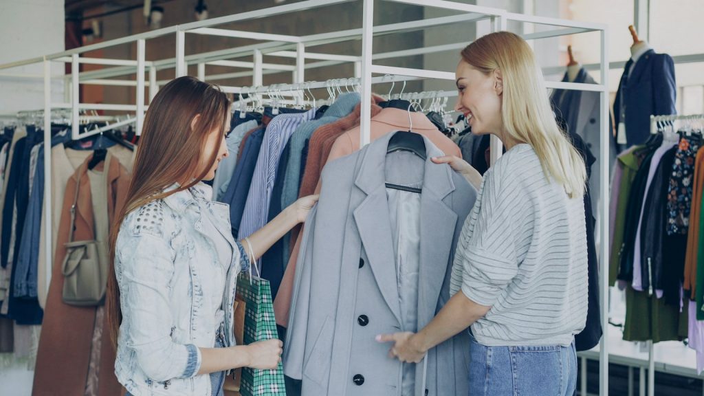 Small business owner speaking with a regular customer, putting customer retention strategies into practice