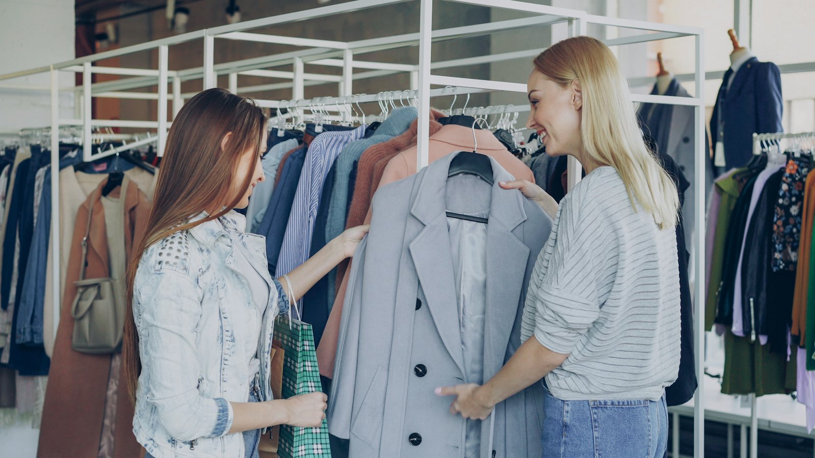 Small business owner speaking with a regular customer, putting customer retention strategies into practice