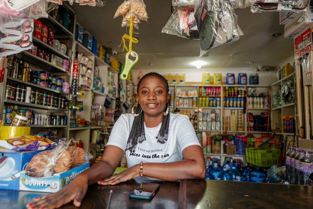 South African small business owner using a phone, an everyday step in digital transformation for small business