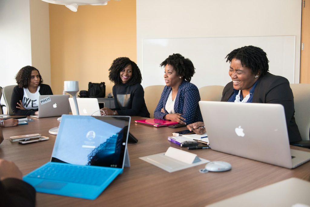 Small business owner and team reviewing small business tools on a laptop in an office