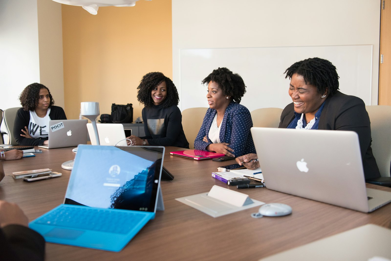 Small business owner and team reviewing small business tools on a laptop in an office
