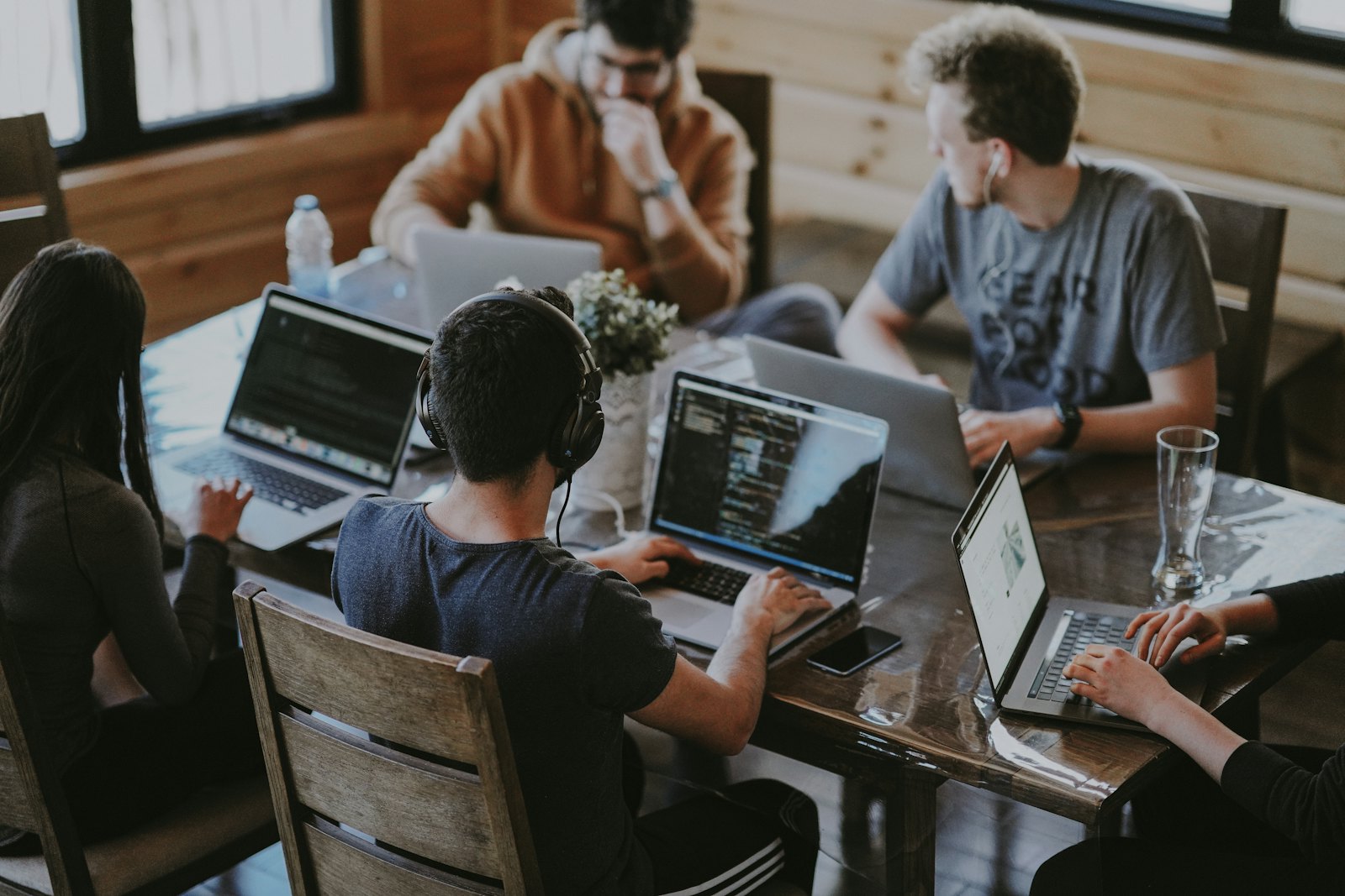 Small startup team reviewing their startup tools and dashboards together in an office